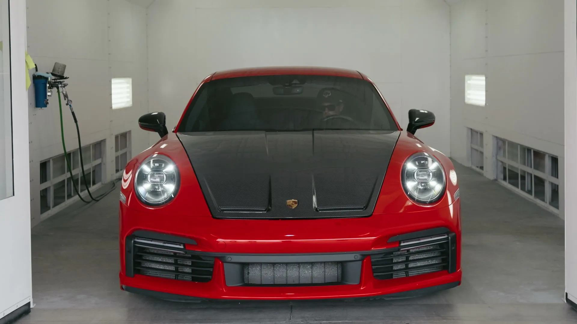 Red Porsche 911 in the spray booth